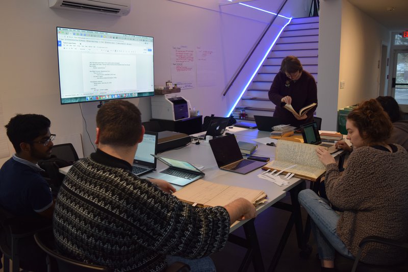 Winter Session Students researching in Sarah K. Hermans's personal collection